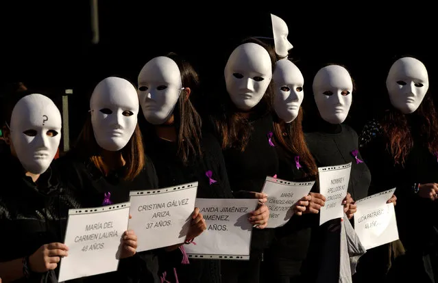 Gender studies students wear masks and hold signs bearing names and ages during a performance to commemorate victims of gender violence, during the U.N. International Day for the Elimination of Violence against Women, in Oviedo, Spain November 25, 2016. (Photo by Eloy Alonso/Reuters)