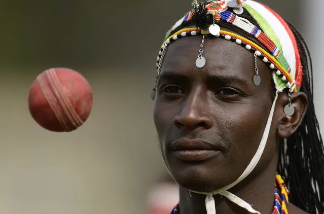 Sonyanga Ole Ngais of the Maasai cricket warrior team from Kenya throws a ball before a cricket match against English team “The Shed” during the Last Man Stands cricket tournament at Dulwich sports ground in south London September 1, 2013. (Photo by Philip Brown/Reuters)