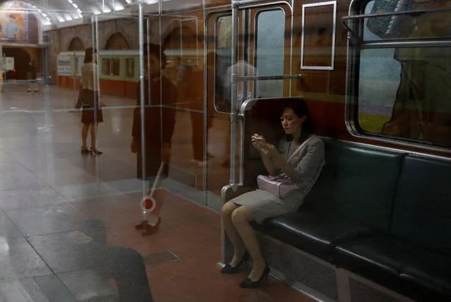 A woman sits in a train at a subway station in Pyongyang, North Korea on September 11, 2018. (Photo by Danish Siddiqui/Reuters)