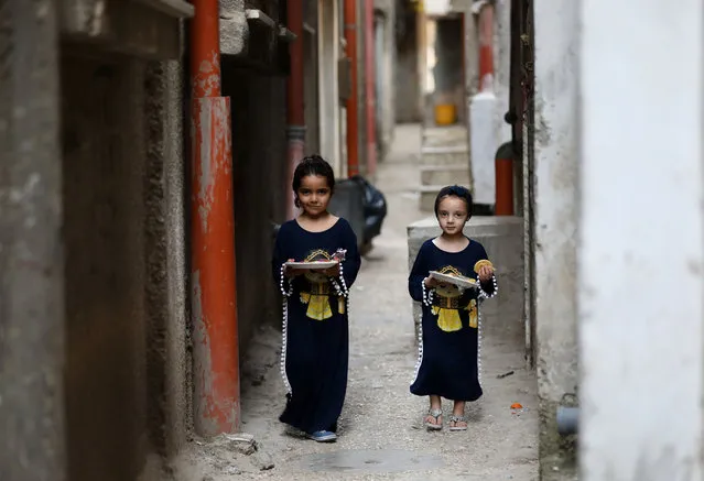 Girls walk in an alley in Balata refugee camp near the West Bank city of Nablus, during the fasting month of Ramadan, on April 20, 2021. (Photo by Chine Nouvelle/SIPA Press/Rex Features/Shutterstock)