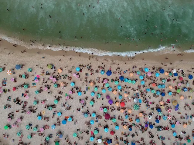 Aerial view of people sunbathing at Copacabana beach in Rio de Janeiro, Brazil, on September 10, 2023. (Photo by Mauro Pimentel/AFP Photo)