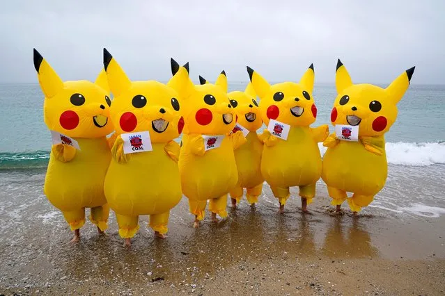 Protesters dressed as Pikachu characters demonstrate on Gyllyngvase Beach, calling on the Japanese government to stop burning coal by 2030, on June 11, 2021 in Falmouth, England. Environmental Protest Groups gather in Cornwall as the UK Prime Minister, Boris Johnson, hosts leaders from the USA, Japan, Germany, France, Italy and Canada at the G7 Summit in Carbis Bay. This year the UK has invited Australia, India, South Africa and South Korea to attend the Leaders' Summit as guest countries as well as the EU. Protest groups hope to highlight their various causes to the G7 leaders and a global audience as the eyes of the world focus on Cornwall during the summit. (Photo by Hugh Hastings/Getty Images)