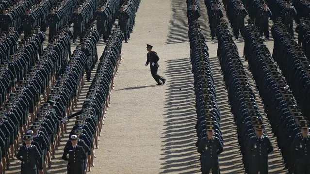 A new South Korean military officer runs into an echelon as they attend a joint commissioning ceremony for 6,478 new officers from the Army, Navy, Air Force and Marines at the military headquarters in Gyeryong March 12, 2015. (Photo by Kim Hong-Ji/Reuters)