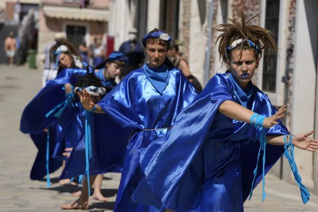 Participants in  fish costumes perform on a protest event of the environmental protection movement Animal Rebellion during the G20 Economy and Finance ministers and Central bank governors' meeting in Venice, Italy, Saturday, July 10, 2021. (Photo by Luca Bruno/AP Photo)