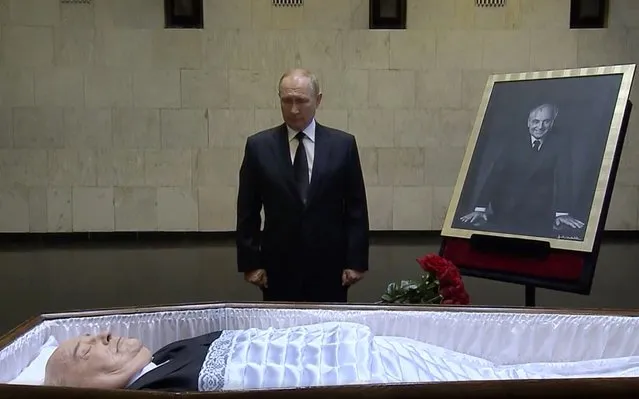 In this image taken from video provided by the Russian pool television on Thursday, September 1, 2022, Russian President Vladimir Putin pays his last respect near the coffin of former Soviet President Mikhail Gorbachev at the Central Clinical Hospital in Moscow Russia. (Photo by Russian pool via AP Photo)