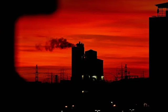 A chemical factory in seen in an industrial area in Frankfurt am Main, western Germany, on November 22, 2023, during sunset. (Photo by Kirill Kudryavtsev/AFP Photo)