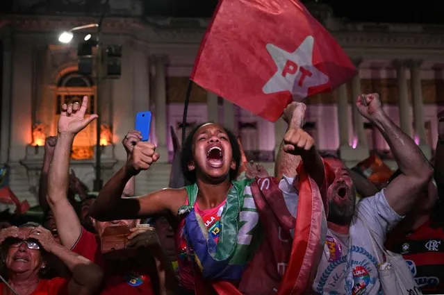 Supporters of Brazilian former President (2003-2010) and candidate for the leftist Workers Party (PT) Luiz Inacio Lula da Silva celebrate after their candidate won the presidential runoff election at the Cinelandia square in Rio de Janeiro, Brazil, on October 30, 2022. Brazil's veteran leftist Luiz Inacio Lula da Silva was elected president Sunday by a hair's breadth, beating his far-right rival in a down-to-the-wire poll that split the country in two, election officials said. (Photo by Pablo Porciuncula/AFP Photo)