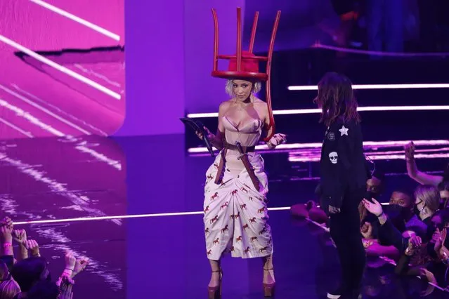 American rapper Amala Ratna Zandile Dlamini, known professionally as Doja Cat holds a chair on her head while presenting an award  onstage during the 2021 MTV Video Music Awards at Barclays Center on September 12, 2021 in the Brooklyn borough of New York City. (Photo by Mario Anzuoni/Reuters)