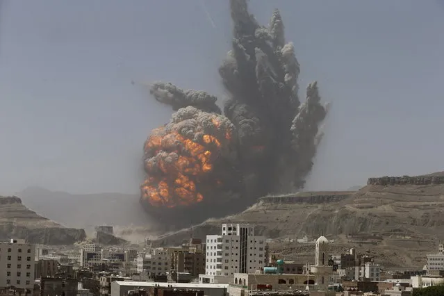 Smoke rises during an air strike on an army weapons depot on a mountain overlooking Sanaa, April 20, 2015. (Photo by Khaled Abdullah/Reuters)