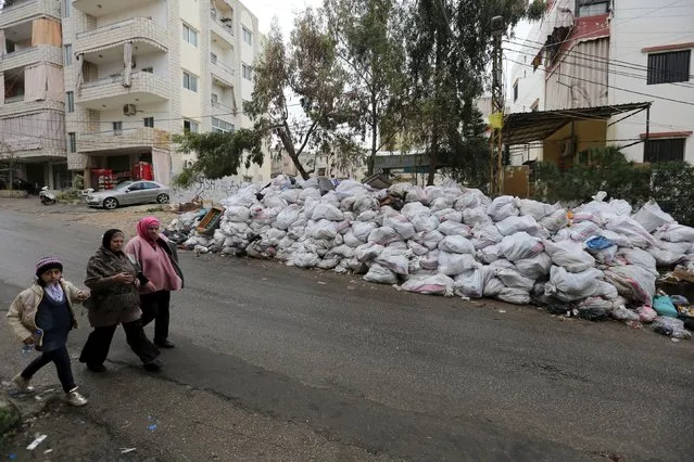 Residents walk near packed garbage in Wadi al-Zayneh, Chouf district, Lebanon March 3, 2016. (Photo by Aziz Taher/Reuters)