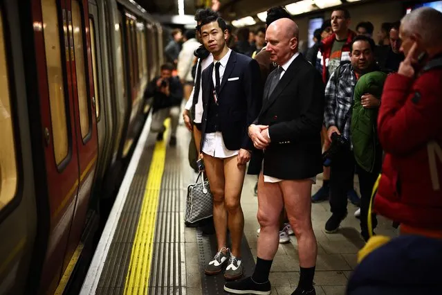 People taking part in the annual “No Trousers On The Tube Day” (No Pants Subway Ride), wait for the metro at a station in the London Underground, in London, on January 7, 2024. The day is now marked in over 60 cities around the world. The idea behind “No Pants” is that random passengers board a subway car at separate stops in the middle of winter, without wearing trousers. (Photo by Henry Nicholls/AFP Photo)