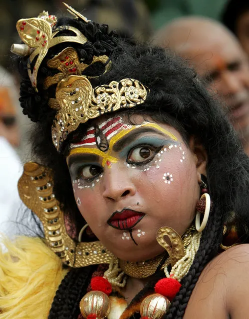 An activist dressed up as Shiva takes part in a protest in New Delhi July 5, 2006. (Photo by Kamal Kishore/Reuters)