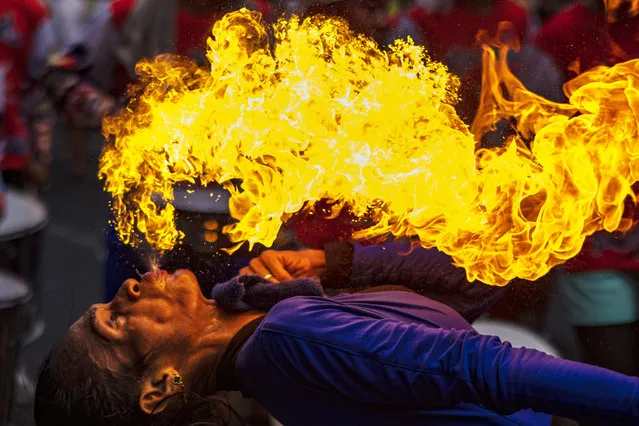 A performer breathes fire during Lunar New Year celebrations at Binondo district, considered the world's oldest Chinatown, on February 10, 2024 in Manila, Philippines. Lunar New Year, also known as Chinese New Year, is celebrated around the world, and the year of the Wood Dragon in 2024 is associated with growth, progress, and abundance, as wood represents vitality and creativity, while the dragon symbolizes success, intelligence, and honor. (Photo by Ezra Acayan/Getty Images)