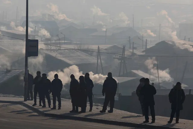 People wait for the bus on a cold polluted day in Ulaanbaatar, Mongolia January 19, 2017. (Photo by B. Rentsendorj/Reuters)