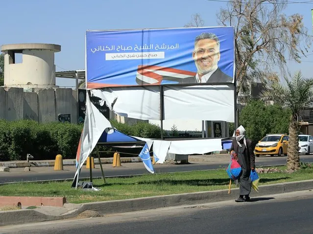Electoral posters for the upcoming parliamentary elections are seen torn in Baghdad, Iraq, Sunday, September 26, 2021. (Photo by Hadi Mizban/AP Photo)