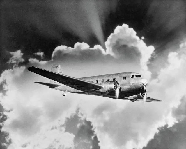 Douglas DC-3 airliner. Advertising image prepared by Aerofilms for a client showing rays of sunshine from behind a cloud.The DC-3 entered civilian service with American Airlines in 1936. (Photo by Aerofilms Collection via “A History of Britain From Above”)