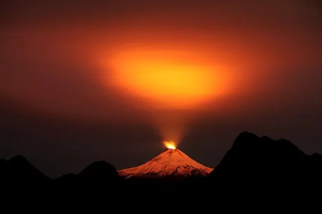 The Villarrica Volcano is seen at night in Pucon town, Chile, May 10, 2015. Villarrica, located near the popular tourist resort of Pucon, is among the most active in South America. (Photo by Cristobal Saavedra/Reuters)