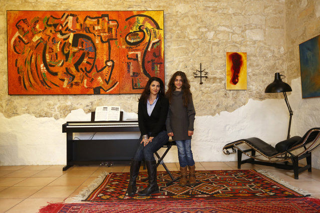Charlotte Stafrace, 49, and her daughter Scarlett Stafarce, 9, pose for a photograph in the living room of their home in Zebbug, outside Valletta March 2, 2014. Charlotte is an actress and freelance drama teacher who finished her education at 17. Charlotte hopes her daughter will be a scientist when she grows up. Scarlett says she will finish education when she's about 25 and that she would like to be a vet. (Photo by Darrin Zammit Lupi/Reuters)
