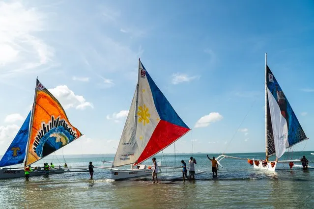 People walks beside the Paraw sail boat during the annual traditional celebration of the Paraw Regatta Festival in Iloilo City, Philippines on March 03, 2024. The Paraw Regatta Festival is a colorful and the largest sailboat race in the Philippines and dubbed as 'The Oldest Traditional Craft Event in Asia'. (Photo by Dante Dennis Diosina Jr II/Anadolu via Getty Images)