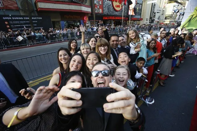 Cast member Ricky Gervais takes a “selfie” with some fans at the premiere of “Muppets Most Wanted” at El Capitan theatre in Hollywood, California March 11, 2014. The movie opens in the U.S. on March 21. (Photo by Mario Anzuoni/Reuters)