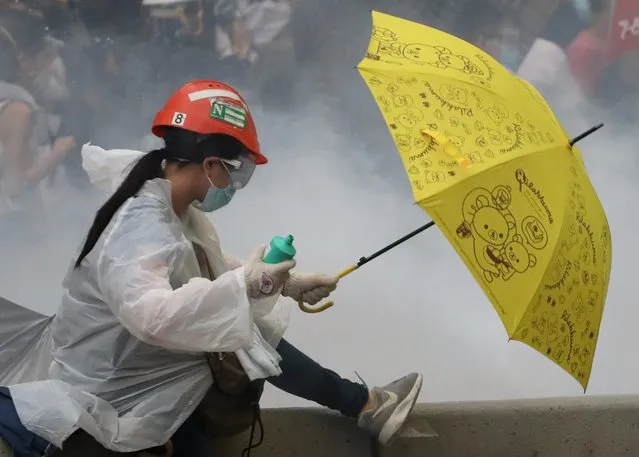 A protester holds an umbrella during a demonstration against a proposed extradition bill in Hong Kong, China on June 12, 2019. (Photo by Athit Perawongmetha/Reuters)