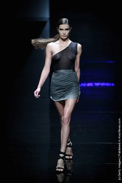 A model showcases designs on the catwalk during Asahi Kasei China Fashion Designer Award Shi Jie Collection of China Fashion Week Spring/Summer 2012