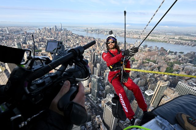 In this image released on May 6, American actor and musician Jared Leto rappels down the Empire State Building in New York City. (Photo by Roy Rochlin/Getty Images for Empire State Realty Trust)