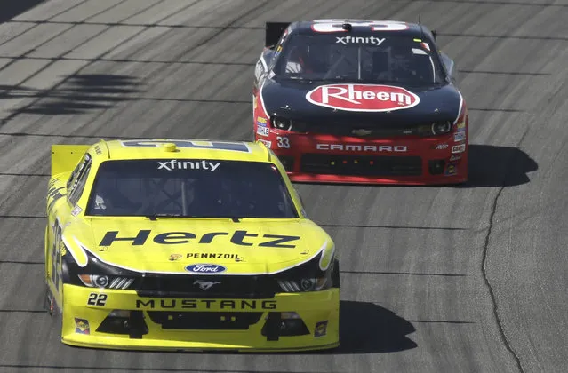 Ryan Blaney (22) drives past Austin Dillon (33) during the NASCAR Xfinity series auto race at Chicagoland Speedway, Sunday, June 21, 2015, in Joliet, Ill. (AP Photo/Nam Y. Huh) 