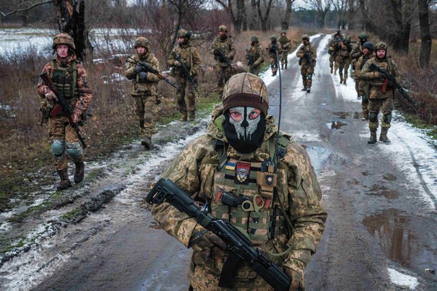 Ukrainian servicemen walk on the road toward their base near the frontline in the Donetsk region on February 4, 2023, amid the Russian invasion of Ukraine. (Photo by Yasuyoshi Chiba/AFP Photo)