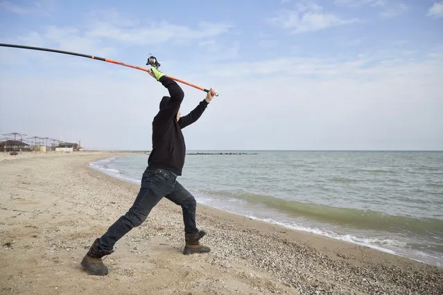 A fisherman tests his new fishing rod on a beach on February 16, 2022 in Prymorsk, Ukraine. (Photo by Pierre Crom/Getty Images)