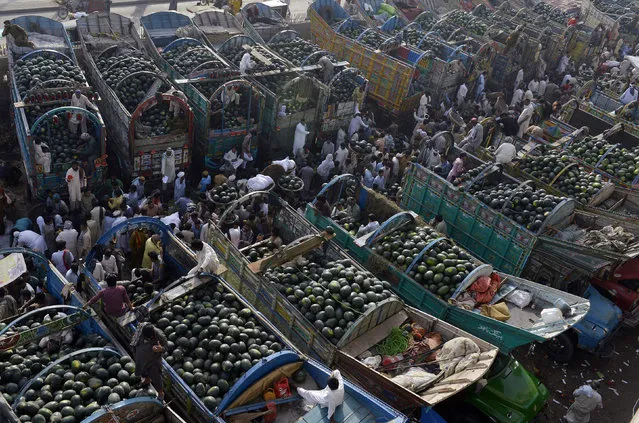 Pakistani farmers gather at a fruit market to sell watermelons in Lahore on April 21, 2016. (Photo by Arif Ali/AFP Photo)