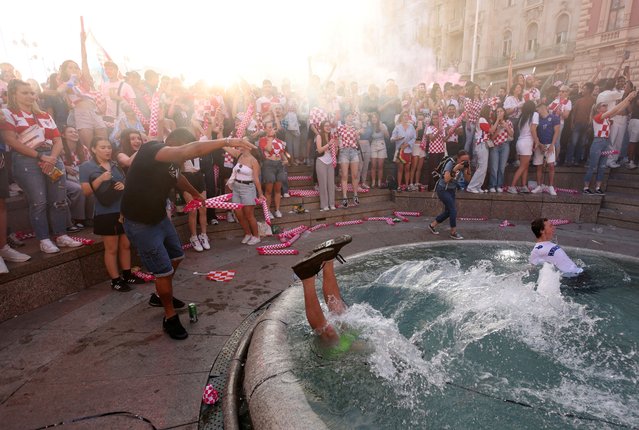 Croatia fans celebrate in a fountain after they score a goal against Spain before it is disallowed as they watch the match at Zagreb's main square during Euro 2024 in Zagreb, Croatia, on June 15, 2024. (Photo by Antonio Bronic/Reuters)