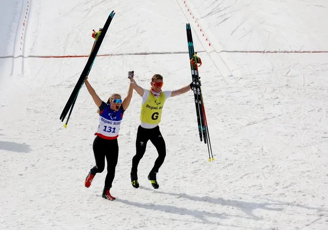 Gold medalist Carina Edlinger of Team Ukraine celebrates with her guide following the Women's Sprint Free Technique Vision Impaired Final on day five of the Beijing 2022 Winter Paralympics at Zhangjiakou National Biathlon Centre on March 09, 2022 in Zhangjiakou, China. (Photo by Gonzalo Fuentes/Reuters)