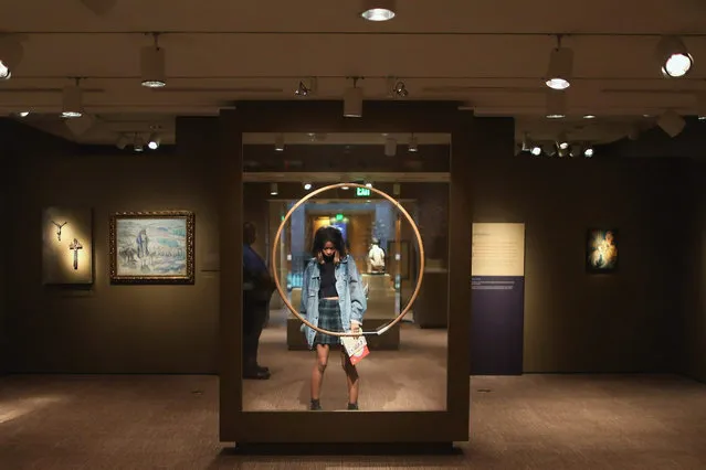 A visitor pauses while looking at the “Conversations: African and African American Artworks in Dialogue” exhibit at the Smithsonian Museum of African Art on the National Mall July 15, 2015 in Washington, DC. The museum posted a message to visitors Tuesday that addresses the allegations of rape made against comedian Bill Cosby, who loaned more than 100 pieces of art to the exhibit. (Photo by Chip Somodevilla/Getty Images)