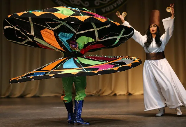 Egyptian dancers Mohamed Al-Hadi Mohamed Al-Damouni (L) and Asma Amr Abdulsalam Mohamed perform at the opening of the 11th Mahmud Esambayev International Solo Dance Festival, at the Vainakh concert hall in Grozny, Chechen Republic, Russia on October 16, 2019. (Photo by Yelena Afonina/TASS)