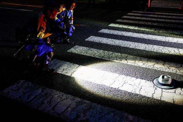 A hat lies on the ground as Police officers work at the site where a car hit a passerby before causing a rollover accident, near Japan's Prime Minister Fumio Kishida official residence, in Tokyo, Japan on June 20, 2024. (Photo by Issei Kato/Reuters)