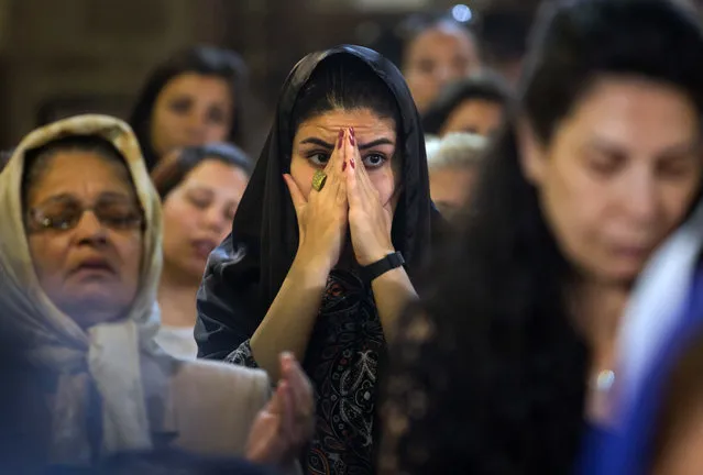 Coptic Christians attend prayers for the departed, remembering the victims of EgyptAir flight 804 at Al-Boutrossiya Church, in the main Coptic Cathedral complex, Cairo, Egypt, Sunday, May 22, 2016. Making his first public comments since the crash of the Airbus A320 while en route from Paris to Cairo, Egyptian President Abdel-Fattah el-Sissi said Sunday it “will take time” to determine the exact cause of the crash, which killed all 66 people on board. (Photo by Amr Nabil/AP Photo)