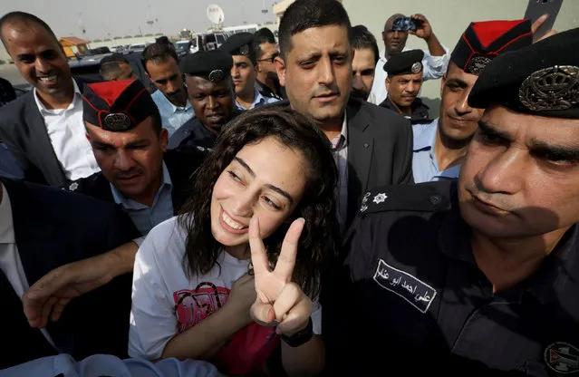 Jordanian citizen Hiba Labadi gestures upon her release by Israel (who was held her for several months), at the King Hussein Bridge crossing near Amman, Jordan, November 6, 2019. Israel had announced on November 4 that it would release Hiba al-Labdi, 24, and Abdelrahman Merhi, 28, two detained Jordanians and that Amman's ambassador would return to the country as a result, bringing an end to a diplomatic dispute between them. Israel has not commented on the reasons for their detention, though Israeli media have reported that they were held on suspicion of security-related offences. (Photo by Muhammad Hamed/Reuters)