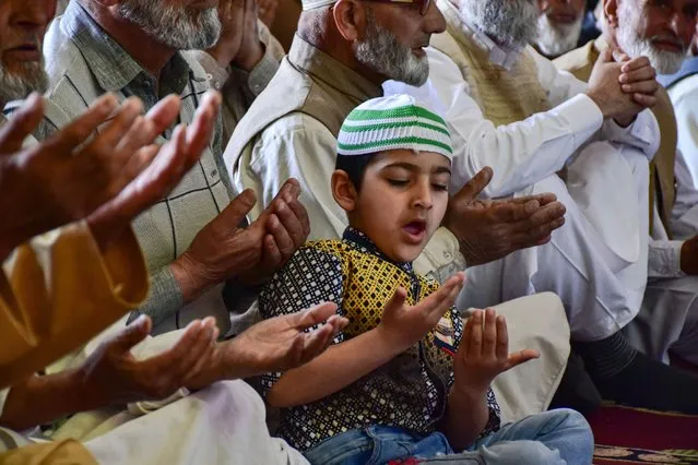 A Kashmiri Muslim boy offers congregational Prayers inside the Grand Mosque (Jamia Masjid) during the first Friday of Ramadan in Srinagar on April 8, 2022. Muslims throughout the world are marking the month of Ramadan, the holiest month in the Islamic calendar during which devotees fast from dawn till dusk. (Photo by Saqib Majeed/SOPA Images/Rex Features/Shutterstock)