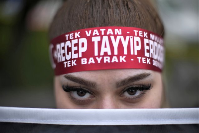 A supporter of President Recep Tayyip Erdogan stands outside the headquarters of AK Party in Istanbul, Turkey, Sunday, May 14, 2023. More than 64 million people, including 3.4 million overseas voters, were eligible to vote in the elections, which come the year the country will mark the centenary of its establishment as a republic – a modern, secular state born on the ashes of the Ottoman Empire. (Photo by Francisco Seco/AP Photo)