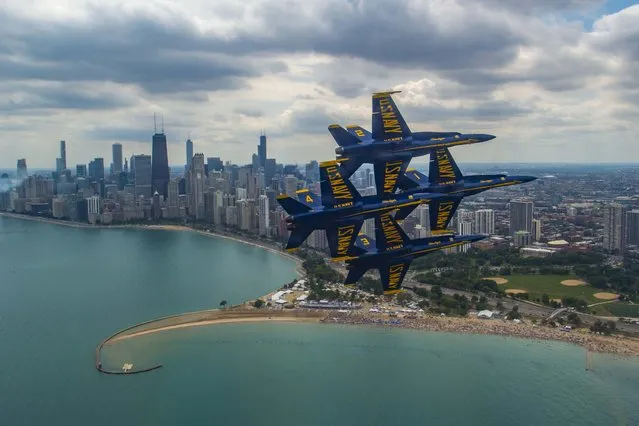 The U.S. Navy Flight Demonstration Squadron, the Blue Angels, diamond pilots perform the diamond 360 during the 2019 Chicago Air and Water Show on August 16, 2019. The Blue Angels are scheduled to conduct 61 flight demonstrations at 32 locations across the country to showcase the pride and professionalism of the U.S. Navy and Marine Corps to the American public in 2019. (Photo by Mass Communication Specialist 1st Class Ian Cotter/U.S. Navy)