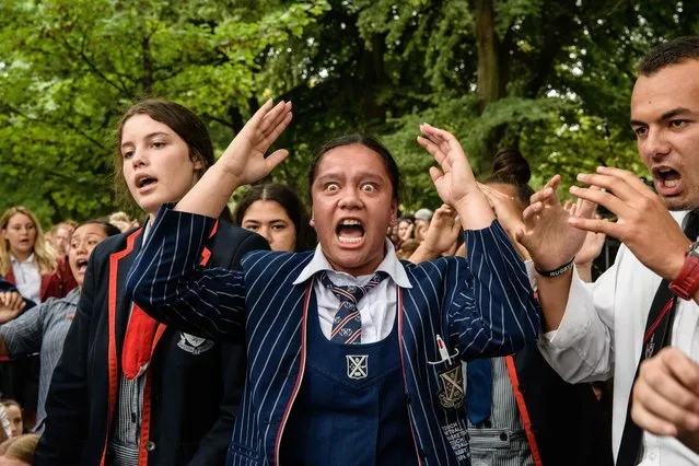 School students perform the haka during a vigil in Christchurch on March 18, 2019, three days after a shooting incident at two mosques in the city that claimed the lives of 50 Muslim worshippers. New Zealand will tighten gun laws in the wake of its worst modern-day massacre, the government said on March 18, as it emerged that the white supremacist accused of carrying out the killings at two mosques will represent himself in court. (Photo by Anthony Wallace/AFP Photo)