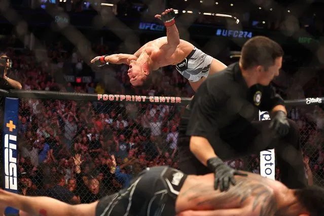 Michael Chandler celebrates with a back flip after knocking out Tony Ferguson  during UFC 274 at Footprint Center in Phoenix, Arizona on May 7, 2022. (Photo by Mark J. Rebilas/USA TODAY Sports)