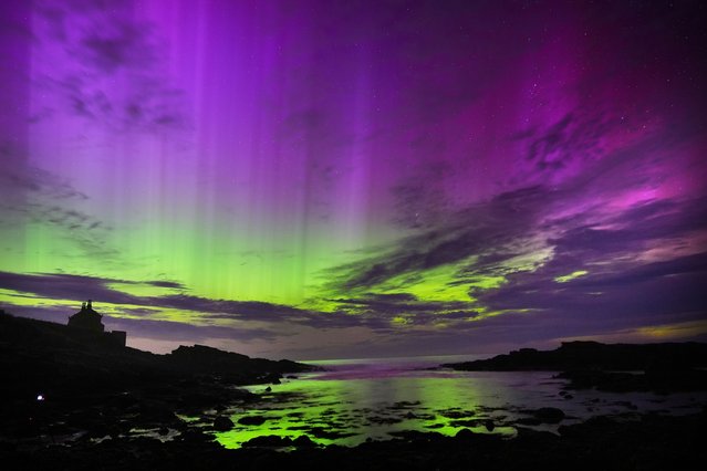 The aurora borealis, also known as the northern lights, fill the sky over The Bathing House in Howick, Northumberland on Monday night and into the early hours of Tuesday, August 13, 2024. (Photo by Owen Humphreys/PA Wire)