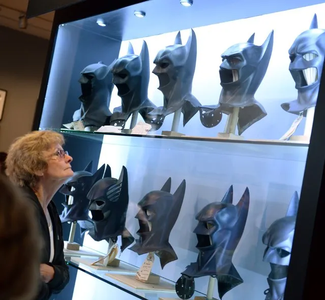 #6: Batman. Web searches for Batman led to unsafe sites in 14.20% of cases, McAfee reports. Pictured here: A visitor looks at Batman masks used in the seven Batman films at The Batman Exhibit on the exhibitions opening day on the Warner Bros. VIP Studio Tours at the Warner Bros. Studio lot in Burbank, California, on June 26, 2014. (Photo by Robyn Beck/AFP Photo)