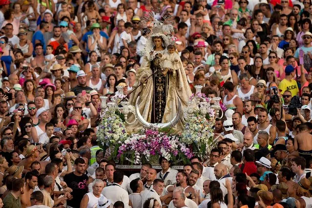 Carriers of the Great God Power brotherhood holds the Virgen del Carmen statue on July 15, 2014 at Puerto de la Cruz dock on the Canary island of Tenerife, Spain. (Photo by Gonzalo Arroyo Moreno/Getty Images)