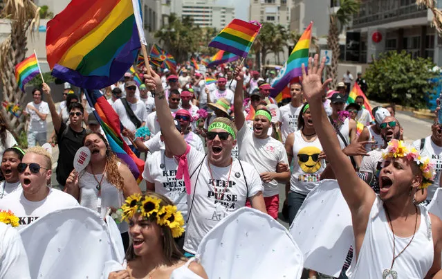 Participants wear T-shirts printed with a tribute to the victims of the shooting at the Pulse night club in Orlando, during the annual gay pride parade in San Juan, Puerto Rico, June 26, 2016. (Photo by Alvin Baez/Reuters)