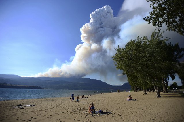 Smoke from the McDougall Creek fire is seen over Okanagan Lake from Kelowna, British Columbia, on Thursday, August 17, 2023. (Photo by Joe O'Connal/The Canadian Press via AP Photo)