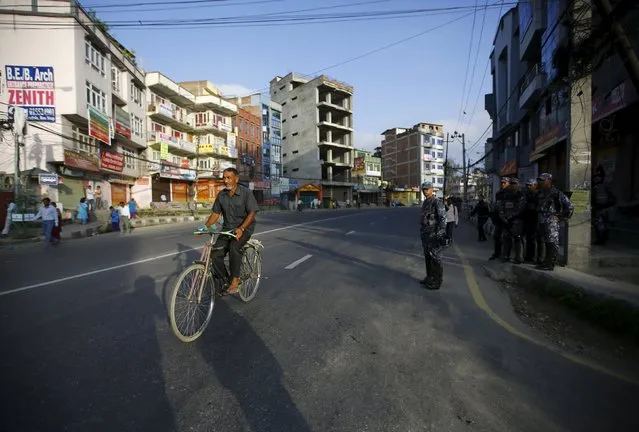 A man rides a bicycle on a deserted road during a general strike organised by a 30-party alliance led by a hardline faction of former Maoist rebels, who are protesting against the draft of the new constitution, in Lalitpur, Nepal August 16, 2015. (Photo by Navesh Chitrakar/Reuters)