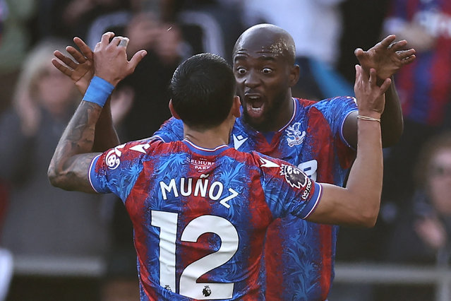 Crystal Palace's French striker #14 Jean-Philippe Mateta (R) celebrates with Crystal Palace's Colombian defender #12 Daniel Munoz (L) after scoring the opening goal of the English Premier League football match between Crystal Palace and Tottenham Hotspur at Selhurst Park in south London on October 27, 2024. (Photo by Henry Nicholls/AFP Photo)